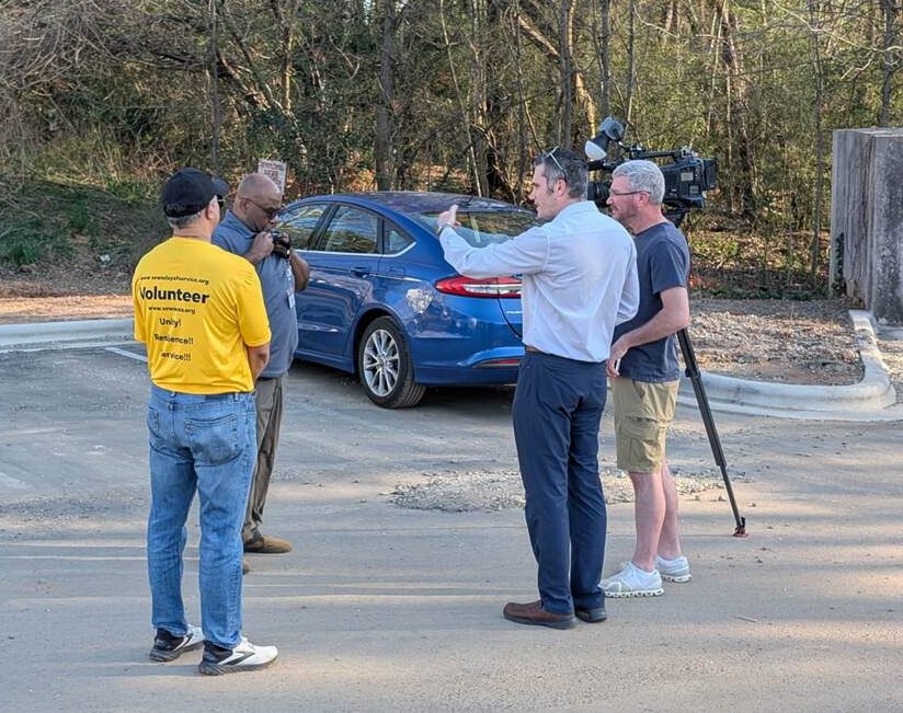 Donnell Nichols speaking with a local television news crew in the field during a disaster response